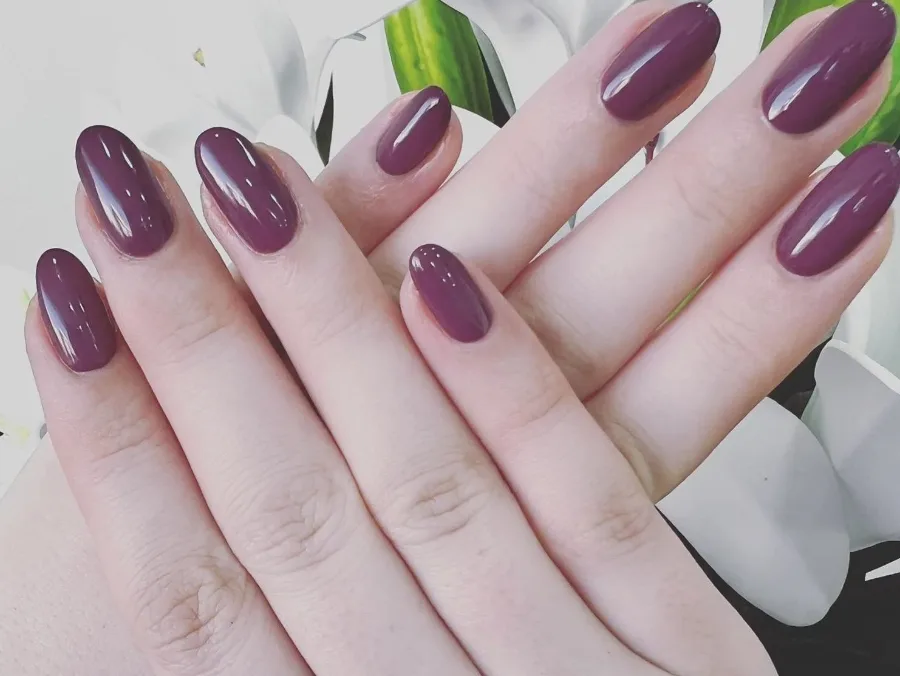 Gel manicure with deep plum polish at Izba Spa Wimbledon nail salon